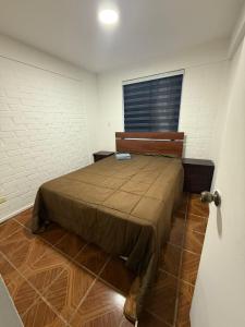 a bedroom with a bed in a room with a window at Departamento cerca de la playa in La Serena