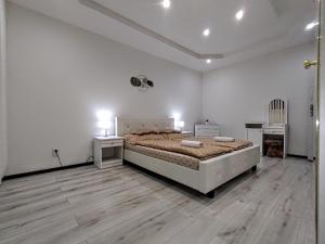 a bedroom with a large bed and a wooden floor at Apartmán Sofia Centrum in Michalovce
