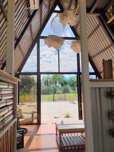 a room with a large window with a view of the beach at A-frame cabin in Palma +19 photos