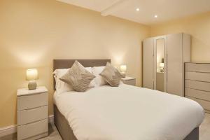 a bedroom with a large white bed with two night stands at Host & Stay - Ross's View in Whitby +12 photos