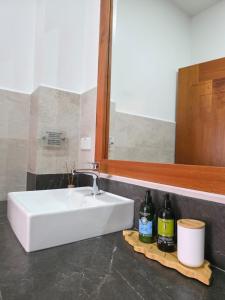 a white sink in a bathroom with a mirror at Casa Galapagos in Puerto Ayora +16 photos