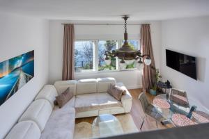 a living room with a couch and a table at Aparatman Residence in Rijeka