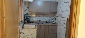 a kitchen with a wall that has been covered in plaster at Dar Fatima in Aït Ali
