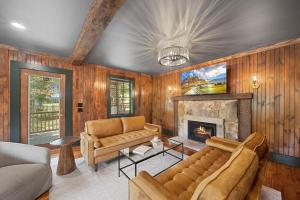 a living room with a couch and a fireplace at The Pink House in Banner Elk