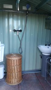 a shower in a bathroom with a sink and a basket at CaravanaStar vistas a la Montaña y Mar como horizonte in Náquera