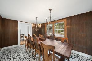 a dining room with a wooden table and chairs at The Pink House in Banner Elk