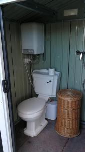 a bathroom with a toilet and a trash can at CaravanaStar vistas a la Montaña y Mar como horizonte in Náquera