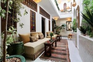 a living room with a couch and some plants at Riad Beata - Private use option - in Marrakech