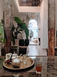 a table with a tea kettle and glasses on it at Riad Beata - Private use option - in Marrakech