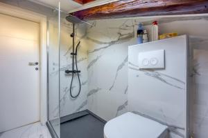 a bathroom with a shower and a toilet at Aparatman Residence in Rijeka +26 photos