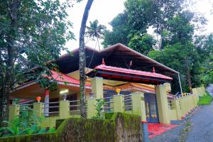 une maison avec un toit rouge dans une rue dans l'établissement Home Near Sabarimala, à Rānī