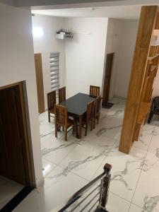 a dining room with a table and chairs at The white luxury Homestay in Thekkady +8 photos