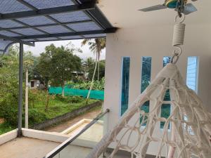 a porch with a hammock and a view of the ocean at The white luxury Homestay in Thekkady