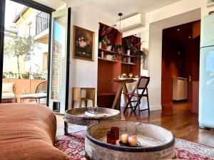 a living room with a couch and a table at L'âme de Nice - Terrasse dorée sur Place Masséna in Nice