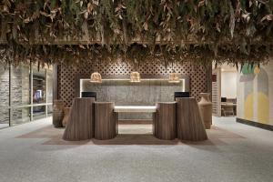 a dining room with a table and some vases at Hotel Indigo Playa del Carmen by IHG in Playa del Carmen