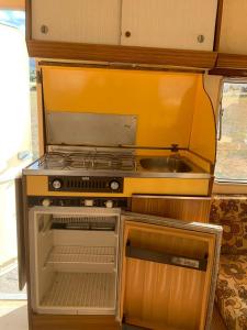 a small kitchen with a stove and a sink at CaravanaStar vistas a la Montaña y Mar como horizonte in Náquera +12 photos