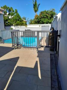a balcony with a view of a swimming pool at Villa de la convenance in Sainte-Marie +8 photos