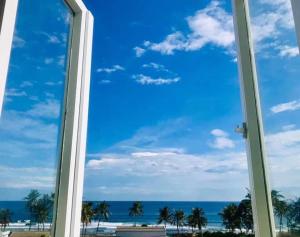 a window with a view of the ocean at Khách Sạn - Homestay QUANG VINH Đảo Lý Sơn in Ly Son