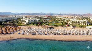 an aerial view of a beach with chairs and umbrellas at Regency Plaza Aqua Park and Spa Resort in Sharm El Sheikh