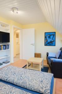 a living room with a couch and a table at Fewo Birnau in Unteruhldingen