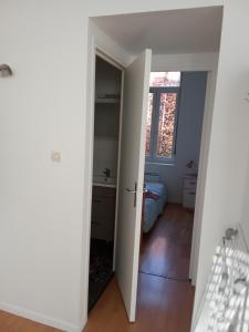 a room with a door leading to a bedroom at Noël centre Lille in Lille