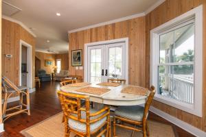 a dining room with a table and chairs at Creekside Cottage in Edisto Island