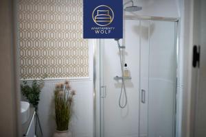 a bathroom with a shower and a sign that reads emergency wolf at Apartament Kaszmirowy in Grudziądz