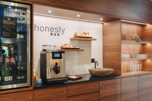 a coffee shop with a coffee machine in a display case at Boutique Hotel Waldegg in Lucerne