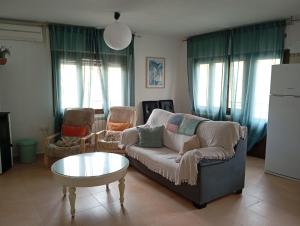 a living room with a couch and a table at La Casa De Marta in Piedralaves +1 photo