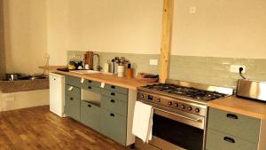 a kitchen with a stove and a counter top at A la belle étoile - Auberge in Mellionnec