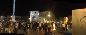 a crowd of people standing in front of a building at night at Scisa de lu Fusulicchiu in Lecce