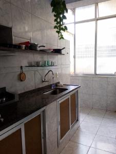 a kitchen with a sink and a large window at Hospedaje en lapa in Rio de Janeiro
