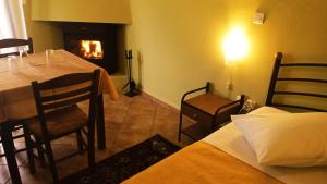a dining room with a table and a fireplace at Guesthouse Eleftherios in Kalavrita