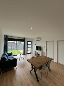 a living room with a table and a couch at Maison Bella Vista in La Celle-sous-Gouzon +3 photos