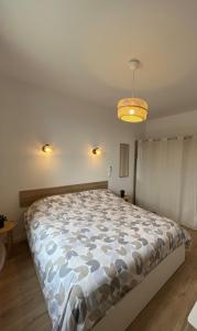 a bedroom with a large bed in a room at Maison Bella Vista in La Celle-sous-Gouzon