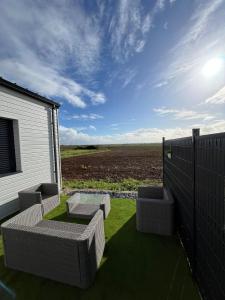 a patio with two chairs and a table and a fence at Maison Bella Vista in La Celle-sous-Gouzon