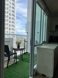 a room with a balcony with a table and a kitchen at Abreeza Tower 1 in Davao City