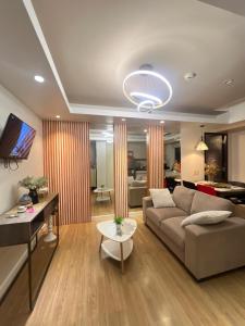 a living room with a couch and a table at Abreeza Tower 1 in Davao City