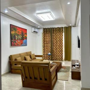 a living room with a couch and a television at 3 Bedroom Dakar Plateau View of Gorée in Dakar +124 photos