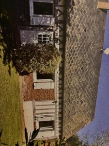 an overhead view of a building with a tree at La petite maison normande in Luneray