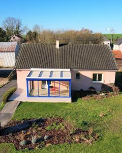 a small house with a blue and white roof at Maison avec véranda - Gîte de l'Arbrisseau in Rethel