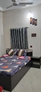 a bedroom with a bed in a room at Diya STAYS in Rāmpur Hāt