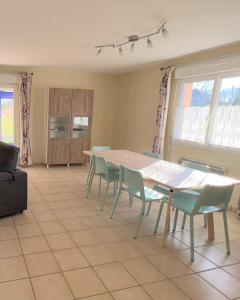 a dining room with a table and chairs at Maison avec véranda - Gîte de l'Arbrisseau in Rethel