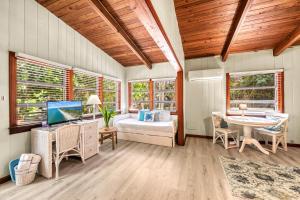 a bedroom with a bed and a desk with a computer at Oak Grove Escape with Shared Deck & Direct Beach Access in Englewood