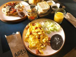 a table with two plates of breakfast foods and drinks at Hotel Aires Bacalar in Bacalar