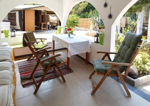 a patio with a table and chairs in a room at Irini Garden House in Vathí
