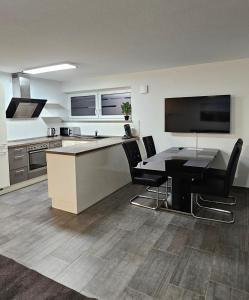 a kitchen with a desk and a table with chairs at MY HOME 23 Nr 8 in Villingen-Schwenningen