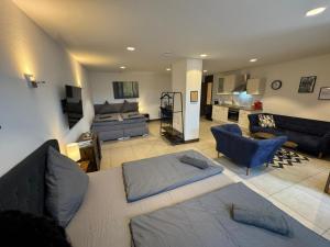 a living room with a bed and a couch at 24-7 Apartments Passau - Ferienwohnung in Passau