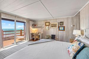 a bedroom with a bed and a view of the ocean at Gulf Front Escape on the Beach with Shared Lounging Deck & Pool in Englewood +52 photos