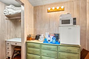 a kitchen with a counter with a microwave and a refrigerator at Gulf Front Escape on the Beach with Shared Lounging Deck & Pool in Englewood